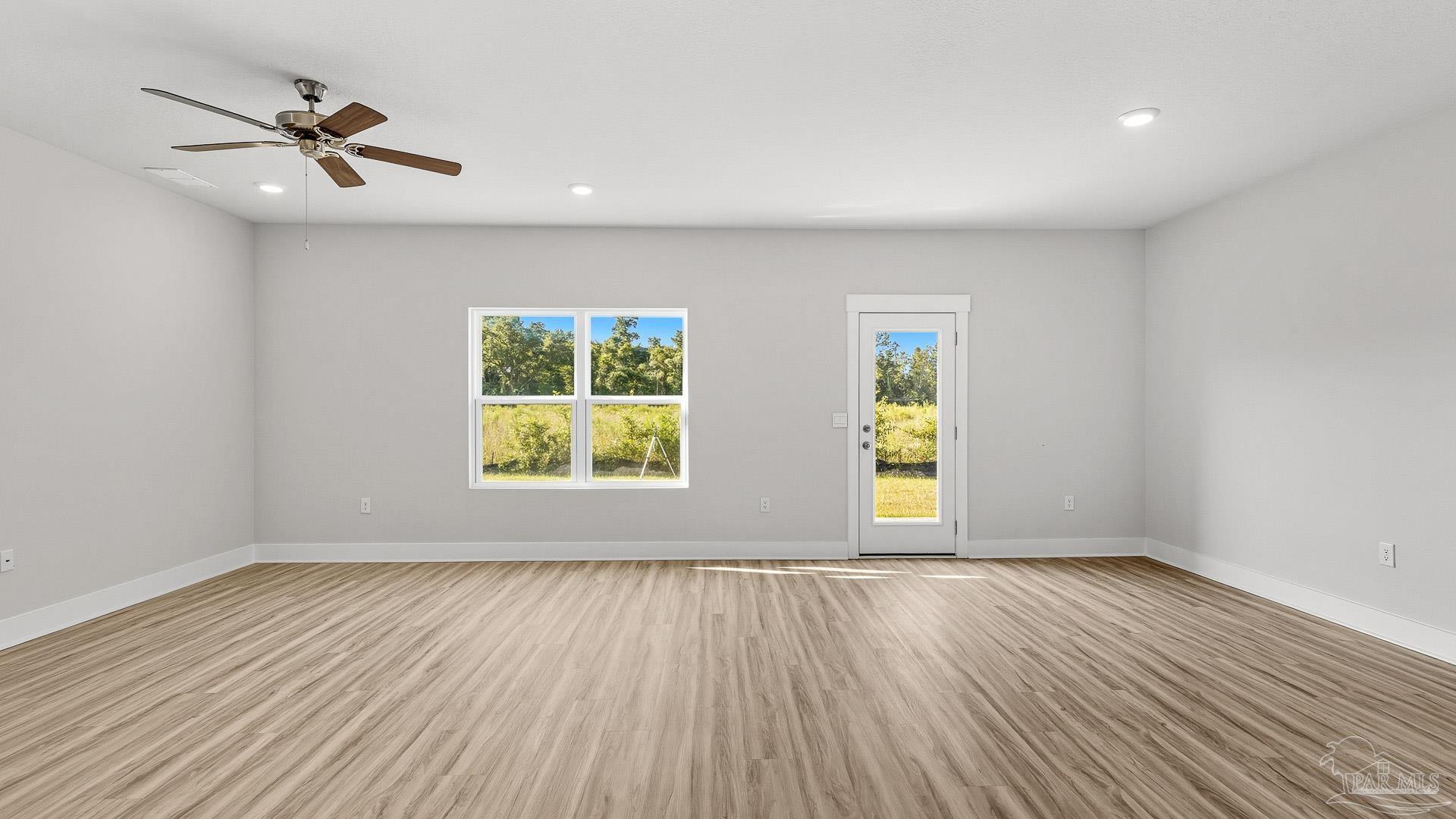136 Albatross Street Cantonment, FL 32533 - Photo 15 of 43 a view of an empty room with a window and wooden floor