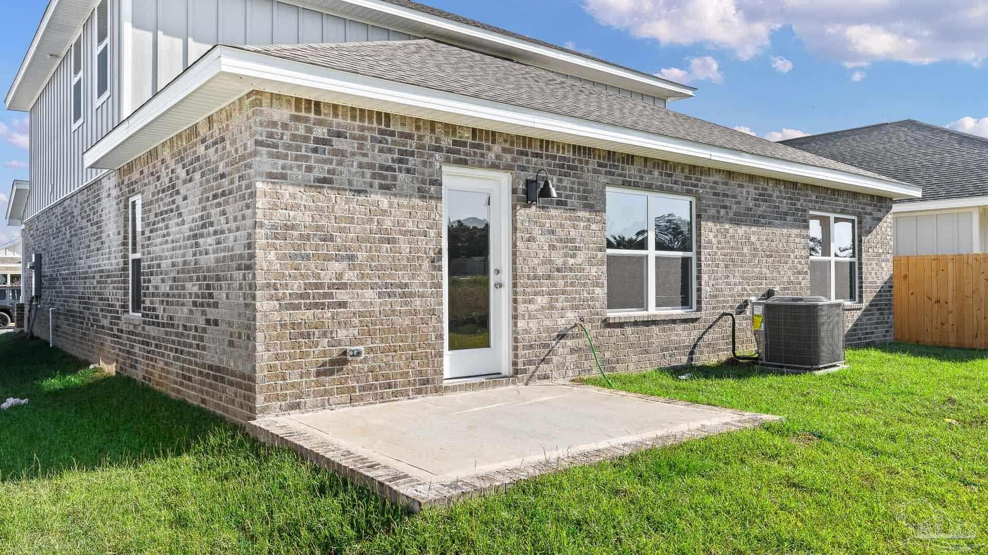 136 Albatross Street Cantonment, FL 32533 - Photo 2 of 43 a front view of a house with yard