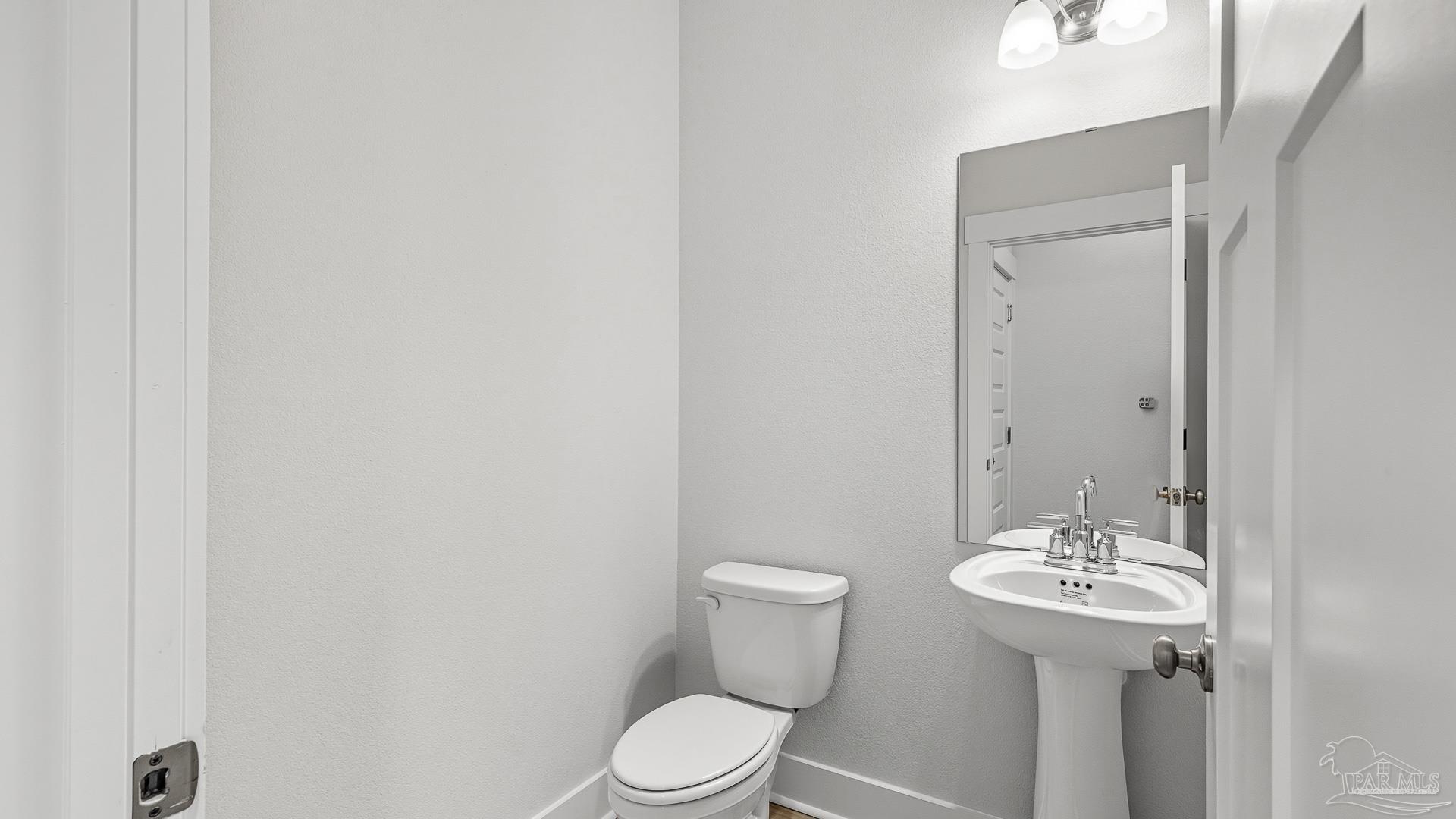 136 Albatross Street Cantonment, FL 32533 - Photo 22 of 43 a bathroom with a sink a toilet and mirror