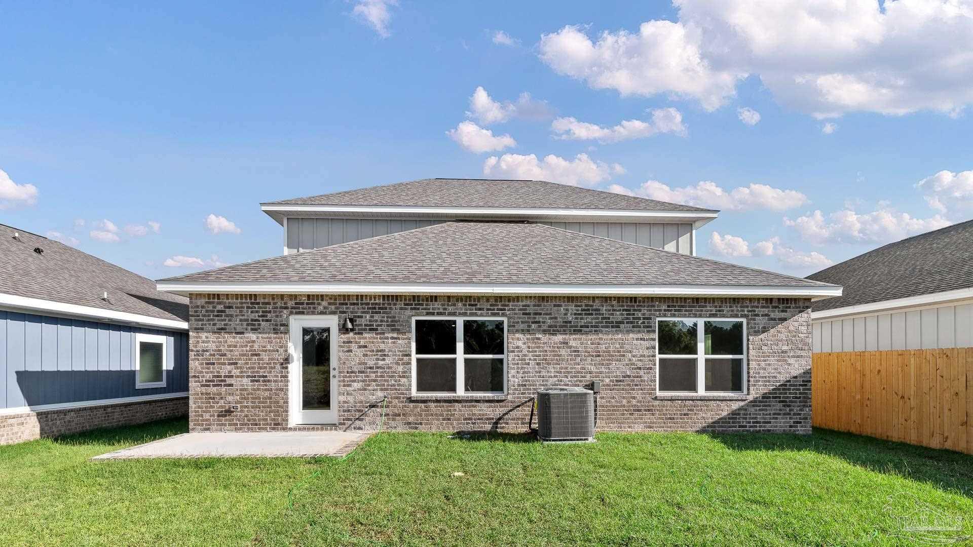 136 Albatross Street Cantonment, FL 32533 - Photo 38 of 43 a front view of a house with a garden and yard