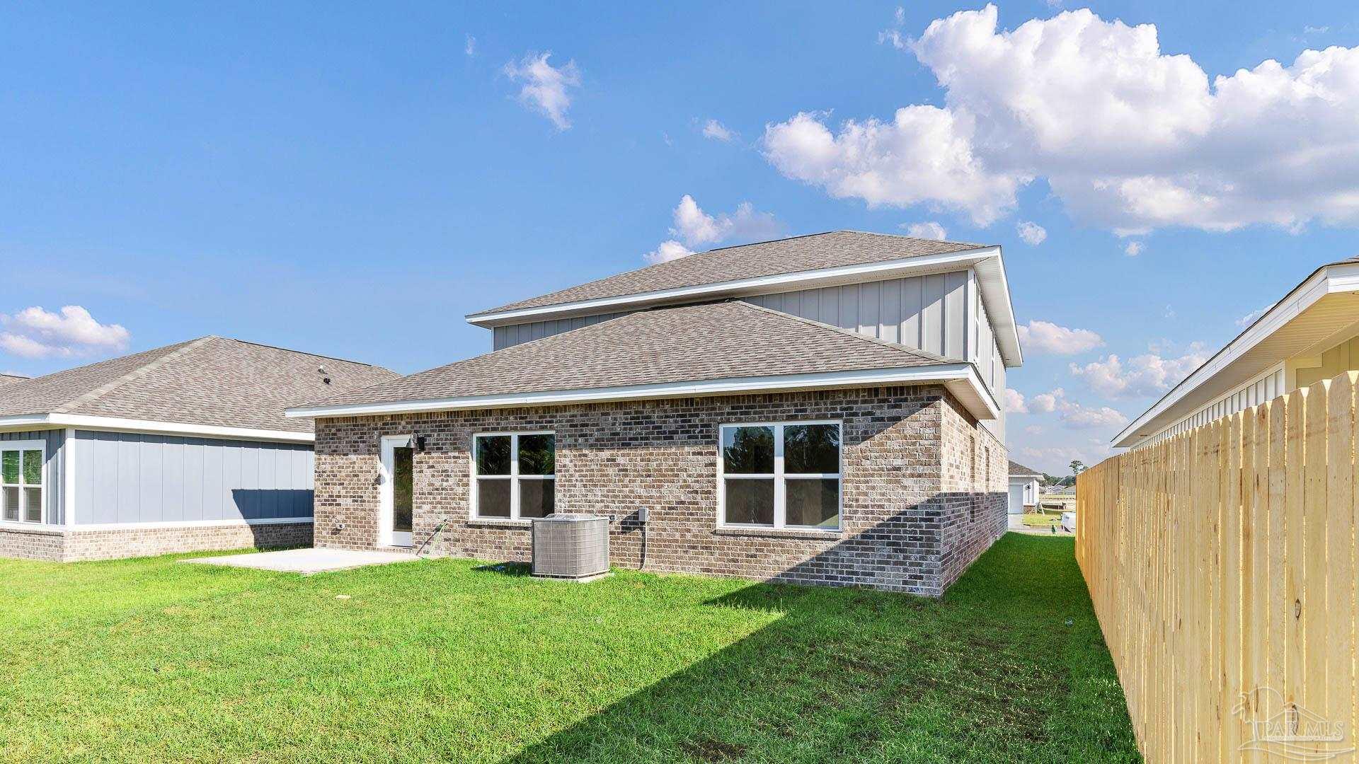 136 Albatross Street Cantonment, FL 32533 - Photo 39 of 43 a front view of a house with a garden