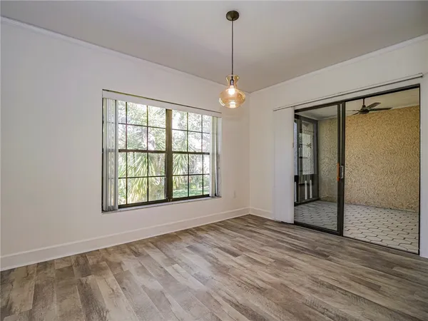 a kitchen with stainless steel appliances granite countertop a sink a stove a refrigerator and white cabinets