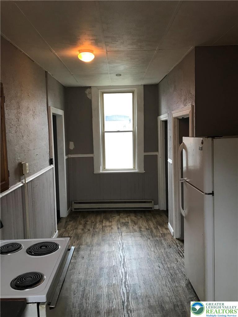 44 Mauch Chunk Street, Unit 7 Tamaqua, PA 18252 - Photo 6 of 8 a kitchen with a refrigerator and a stove