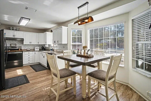 a kitchen with stainless steel appliances granite countertop a refrigerator a stove and cabinets