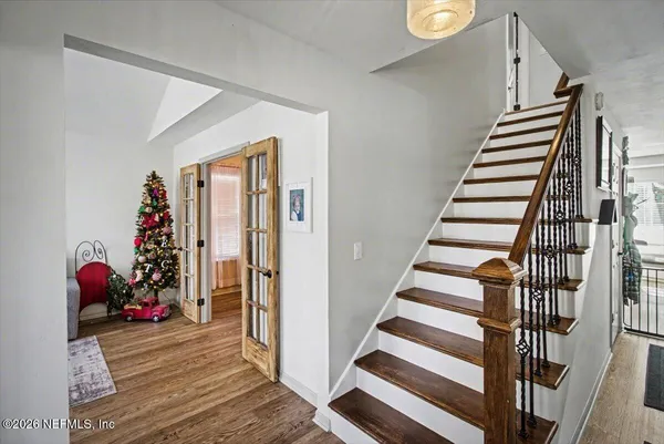 a view of entryway with wooden floor and stairs