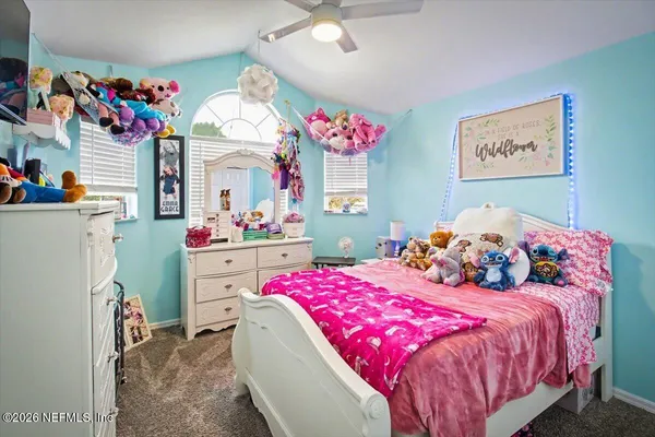 a bedroom with a bed closet and window