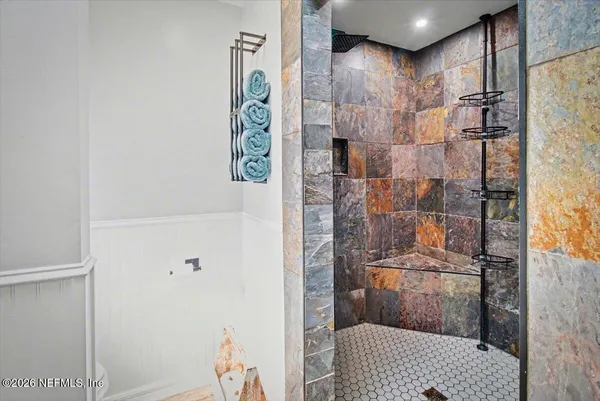 a living room with furniture a flat screen tv and a window