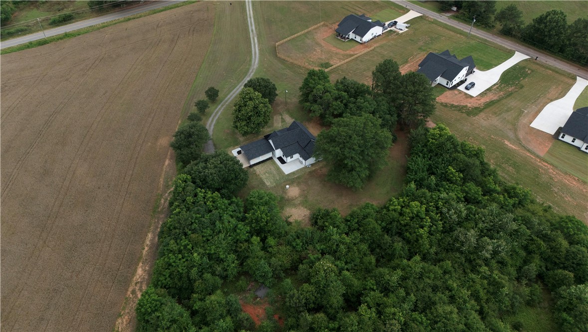 2817 Broadway Lake Road Anderson, SC 29621 - Photo 39 of 41 Discover a tranquil rural property featuring a modern home nestled amongst natural surroundings with expansive fields.