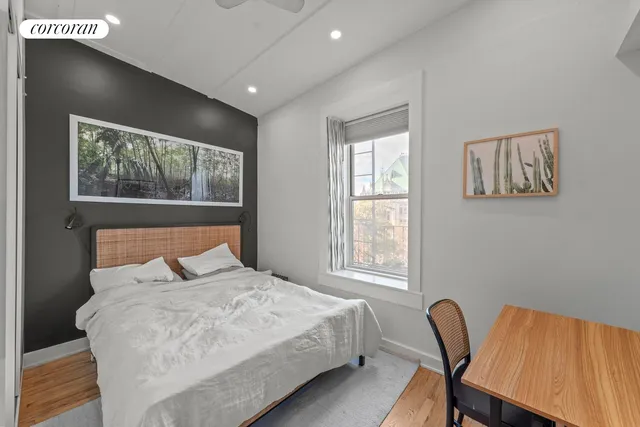 a bedroom with a bed and a chair