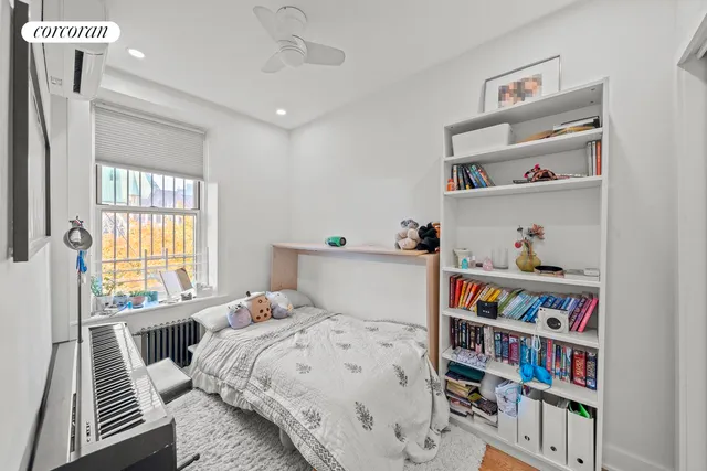 a bedroom with a bed and a book shelf