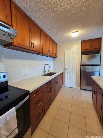 a kitchen with stainless steel appliances granite countertop a sink stove and cabinets