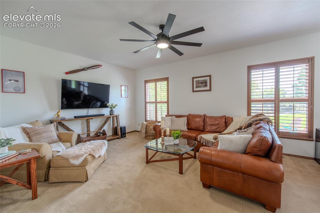 789 Capeglen Road Colorado Springs, CO 80906 - Photo 18 of 46 Main floor family room with plantation shutters, access to half bath