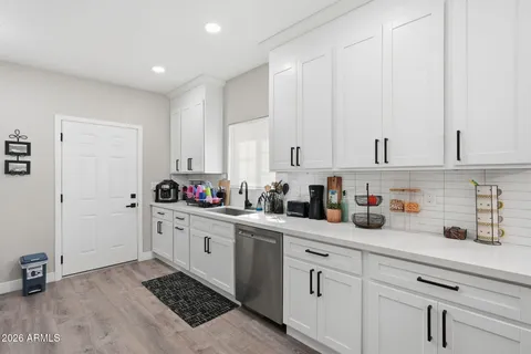a kitchen with white cabinets and white appliances