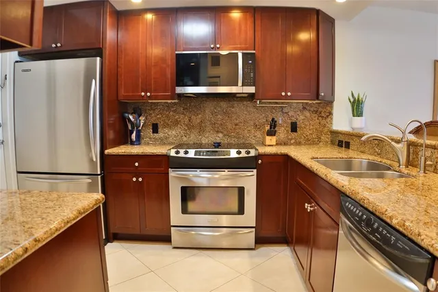 a kitchen with a sink a stove and cabinets