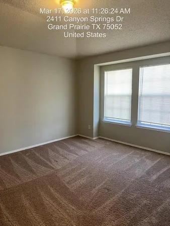 a view of an empty room and a window