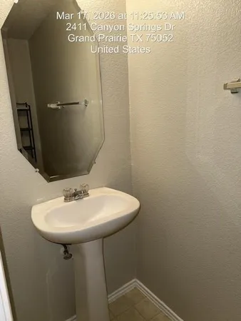 a bathroom with a toilet and a mirror
