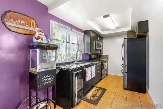 a kitchen with stainless steel appliances granite countertop a stove and a refrigerator
