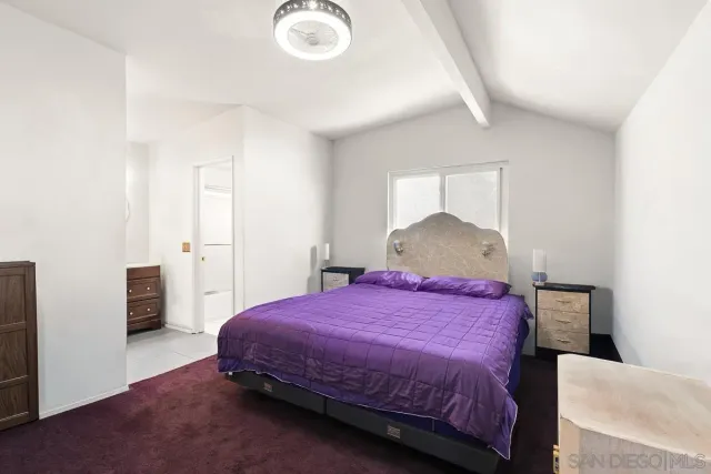 a bedroom with a bed and a table