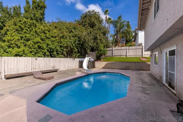 a view of a backyard with a garden and outdoor seating