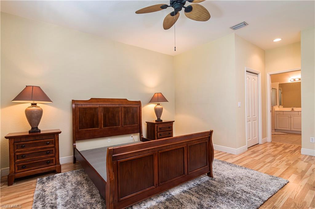 20058 Serre Drive Estero, FL 33928 - Photo 12 of 22 a bedroom with a bed and wooden floor
