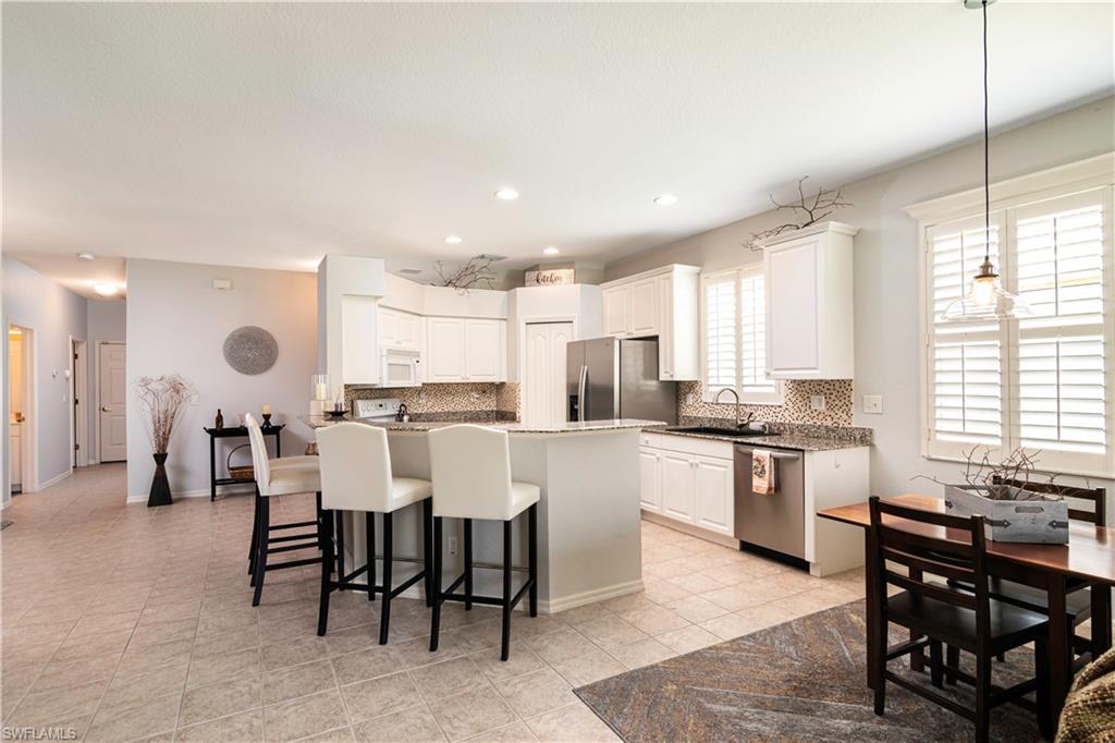 20058 Serre Drive Estero, FL 33928 - Photo 4 of 22 a large kitchen with a table and chairs