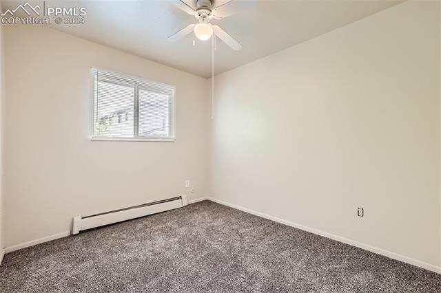 6450 Chippewa Road Colorado Springs, CO 80915 - Photo 9 of 10 Bedroom 2: Carpeted spare room with ceiling fan and baseboard heating