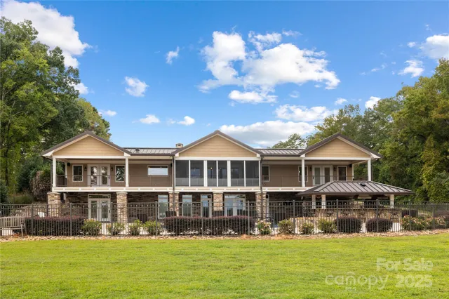a front view of a house with yard swimming pool and outdoor seating