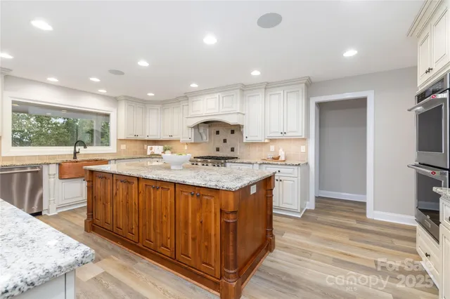 a kitchen with granite countertop a stove and a sink