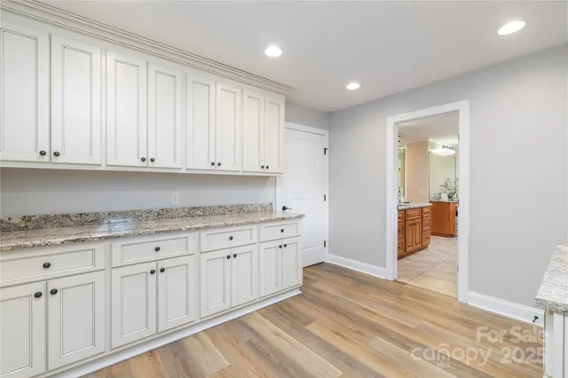 a view of a kitchen with granite countertop cabinets