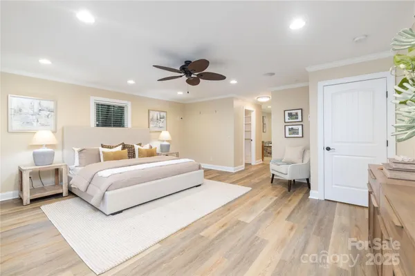 a spacious bedroom with a bed and a couch