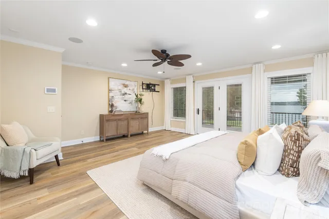 a spacious bedroom with a bed and ceiling fan