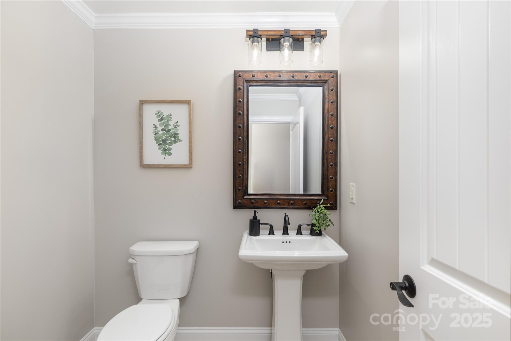 11133 Willow Oak Road Norwood, NC 28128 - Photo 20 of 48 a bathroom with a toilet sink and mirror