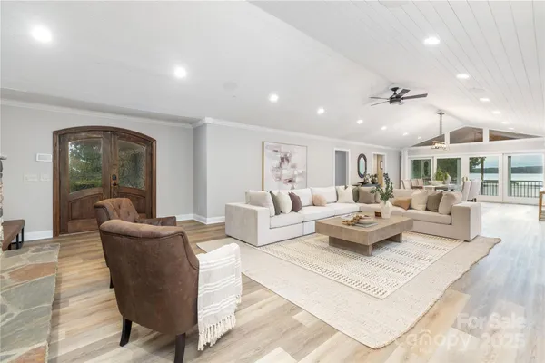 a living room with furniture potted plant and a table