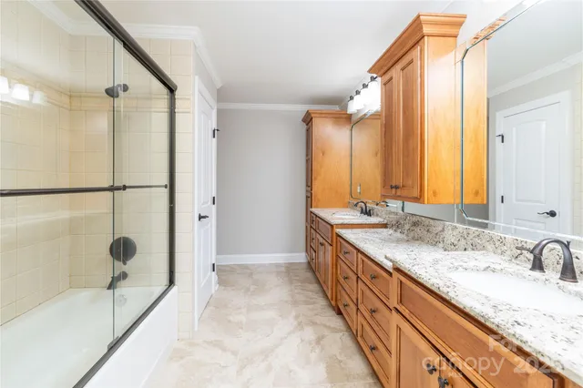 a bathroom with a granite countertop tub sink and mirror
