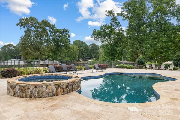 a view of a swimming pool with a yard