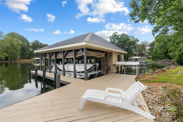 a view of a house with swimming pool and sitting area