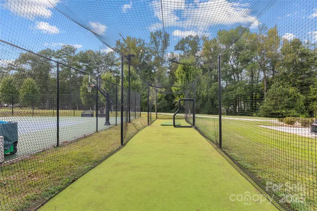 a swimming pool with trees in the background