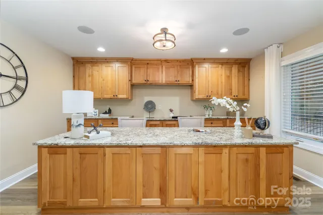 a kitchen with granite countertop a sink a window and a granite counter tops