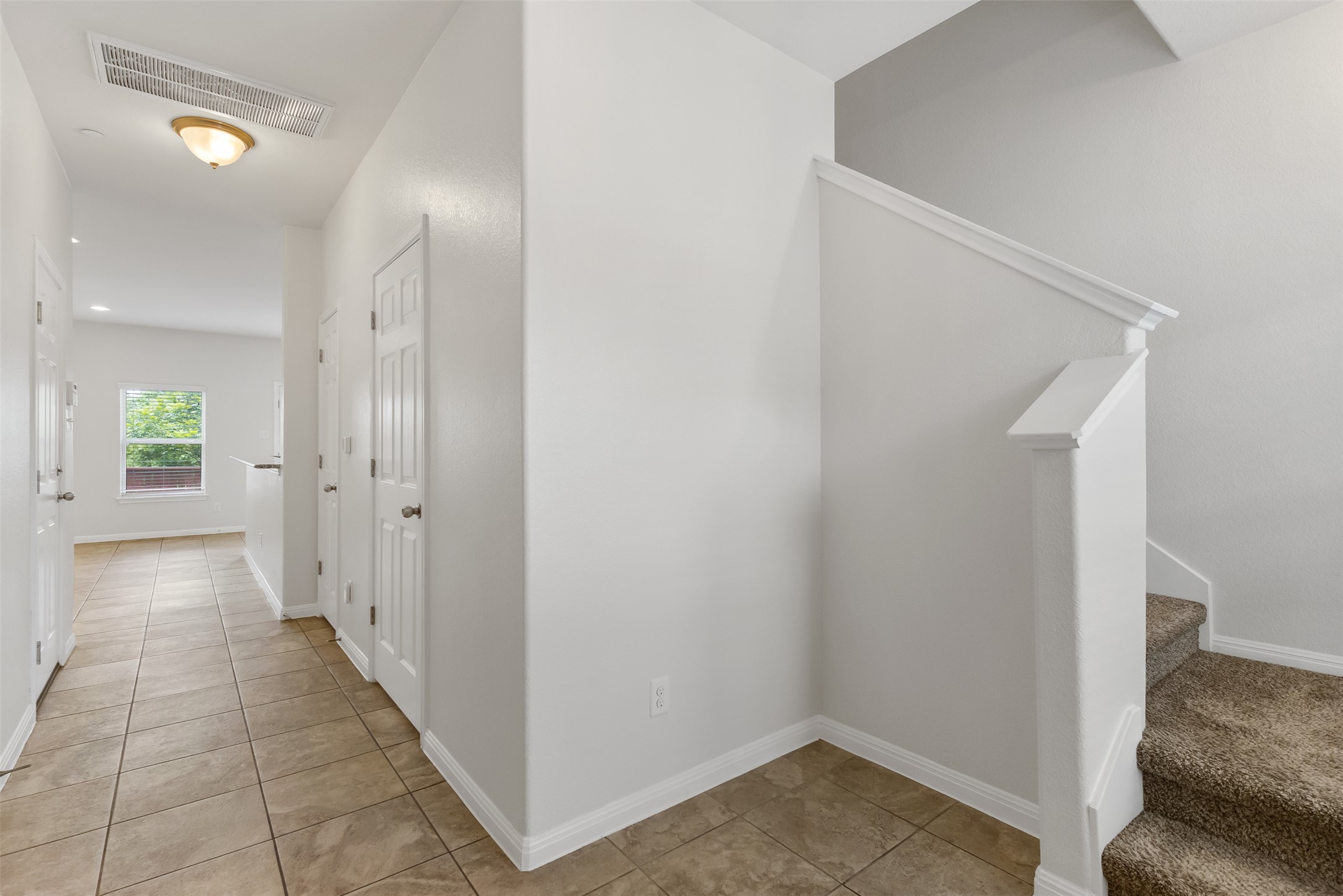 1510 Catalan Road, Unit 602 Austin, TX 78748 - Photo 6 of 36 Hallway with light tile patterned floors and stairway