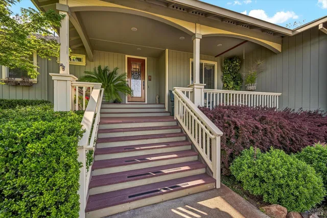 a view of a house with fountain and a porch