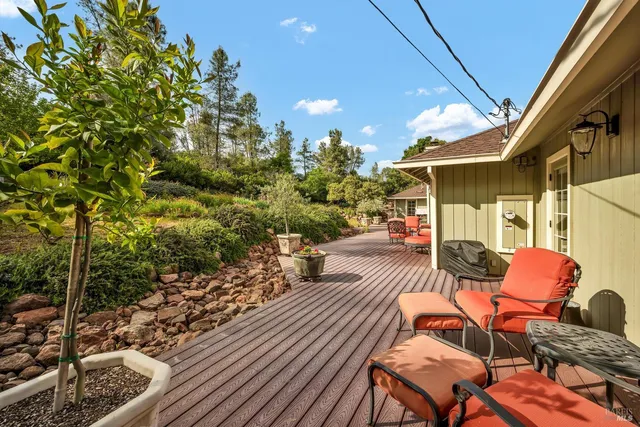 a view of a patio with couches table and chairs and potted plants