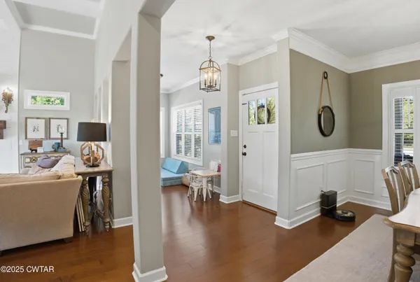 a living room with furniture and a chandelier