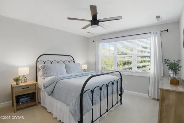 a bedroom with a bed next to a window