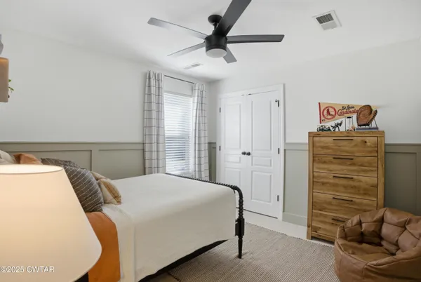 a bedroom with a bed and a ceiling fan