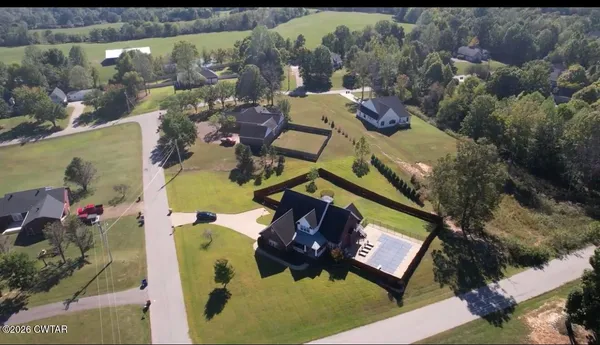 an aerial view of a house with a swimming pool