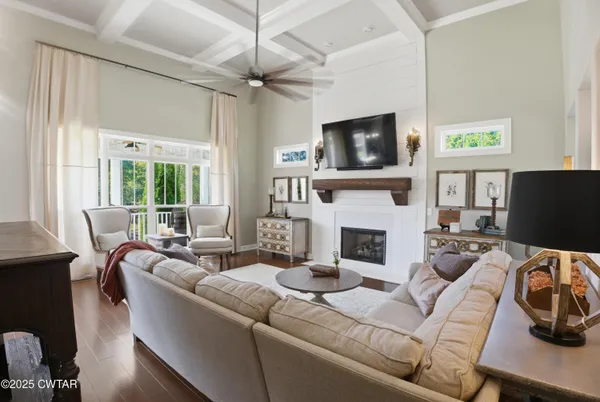 a living room with furniture a flat screen tv and a fireplace