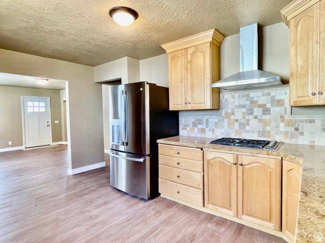255 West Main Street Mount Pleasant, UT 84647 - Photo 4 of 35 Kitchen featuring light wood-finish cabinetry, granite-style countertops, stainless steel appliances, and a mosaic tile backsplash