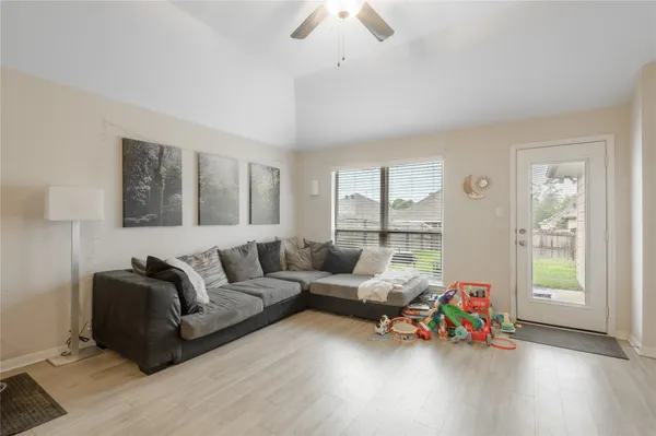a living room with furniture and wooden floor