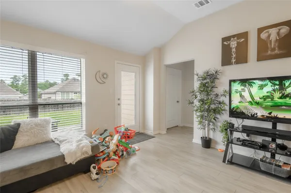a living room with furniture and a floor to ceiling window