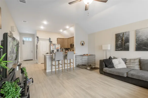 a living room with furniture and a wooden floor